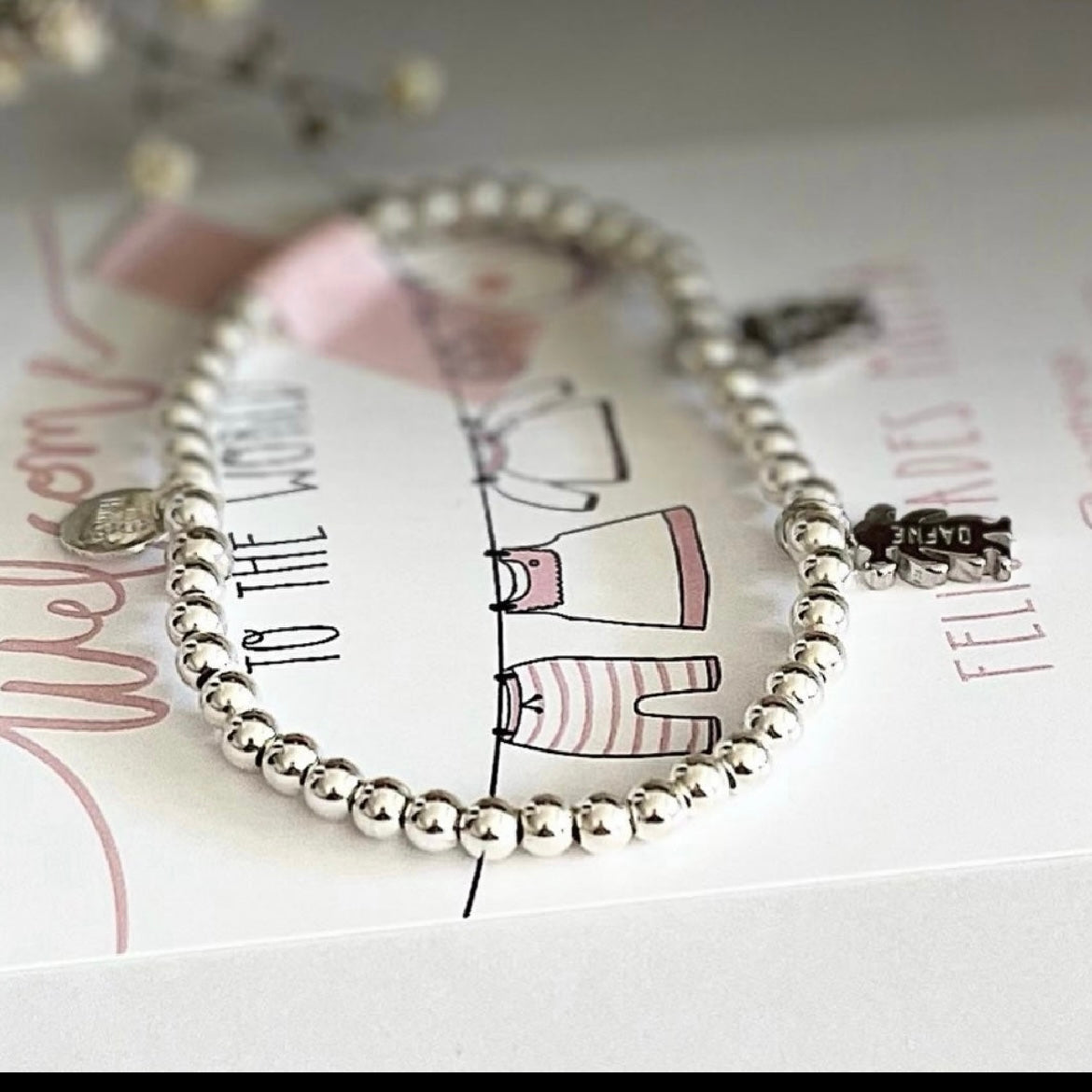 Pulsera personalizada con bolitas de plata y charm de niño o niña.