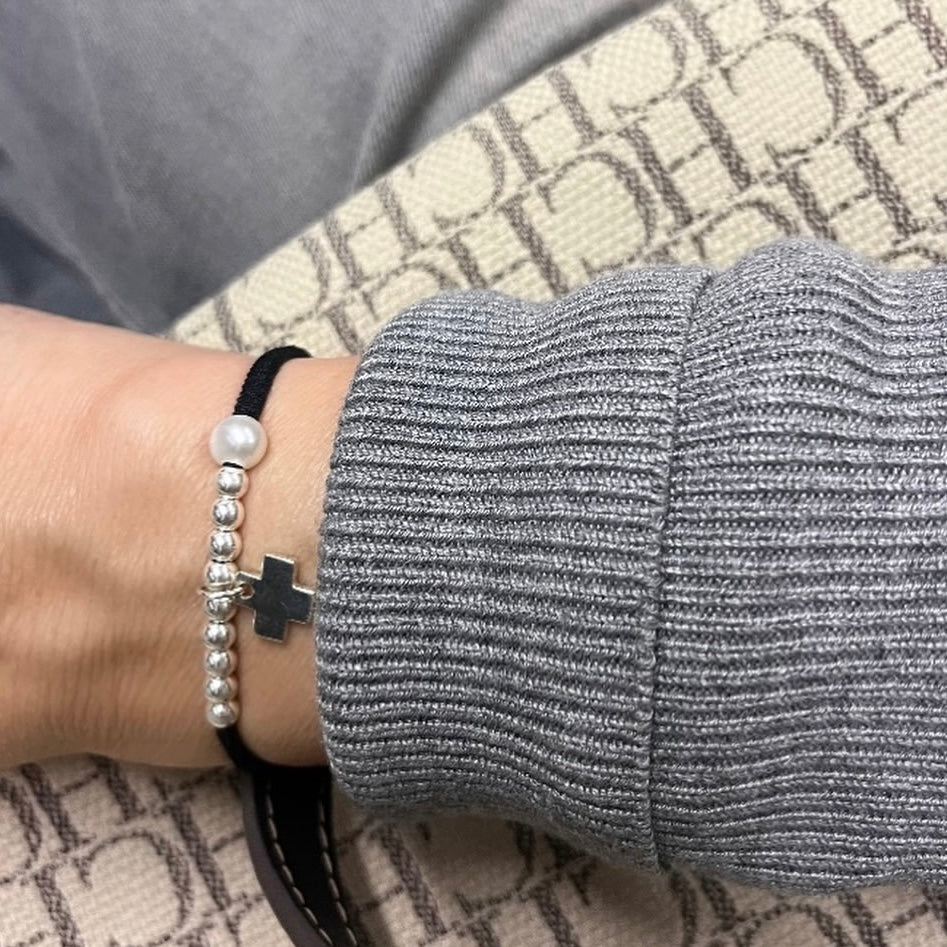 Pulsera con cinta elástica y cruz personalizada.